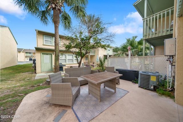 view of patio with grilling area, cooling unit, a balcony, and an outdoor hangout area