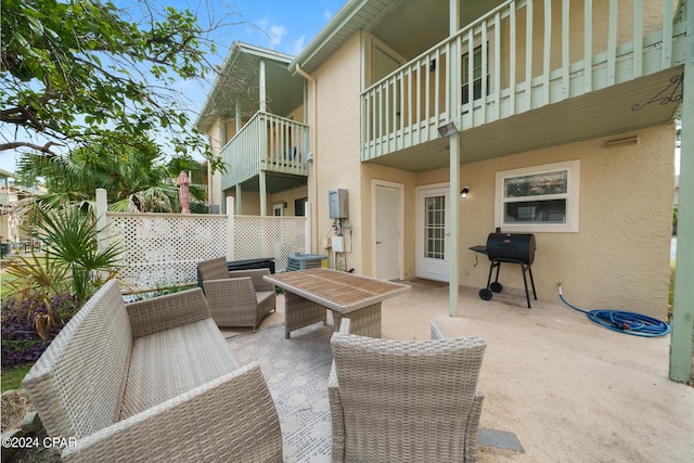 view of patio / terrace with a balcony, central AC, an outdoor living space, and area for grilling