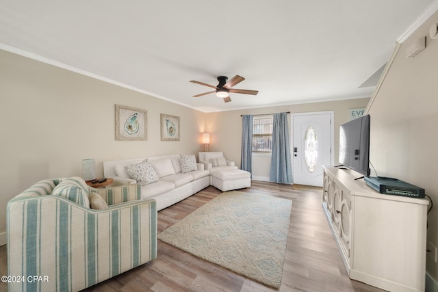 living room with crown molding, light wood-type flooring, and ceiling fan