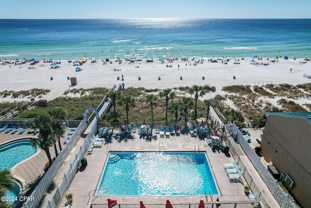 drone / aerial view featuring a water view and a view of the beach