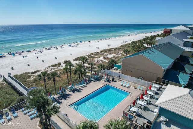 drone / aerial view featuring a water view and a beach view