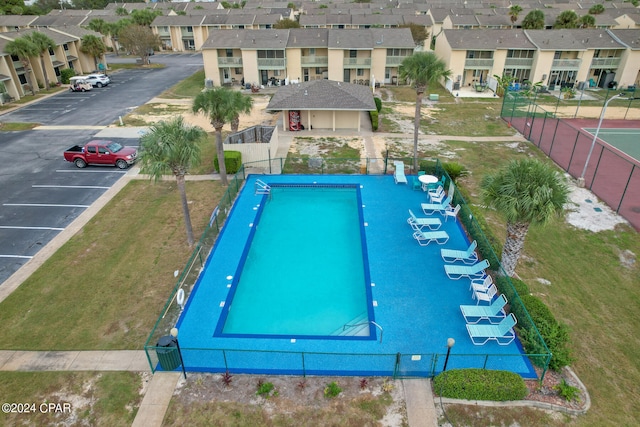 view of pool with a lawn