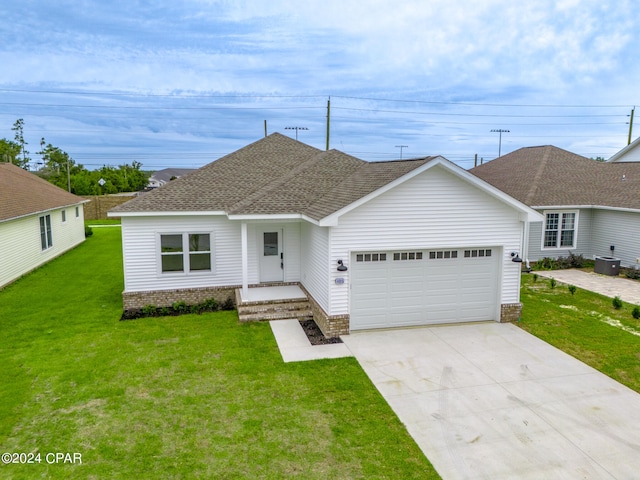 ranch-style house featuring a front lawn and a garage