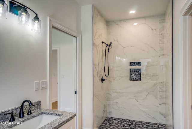 bathroom featuring vanity and a tile shower