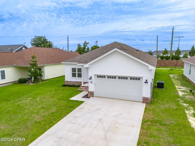 ranch-style house with a garage, cooling unit, and a front lawn