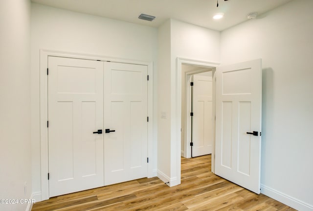 interior space with a closet and light hardwood / wood-style flooring