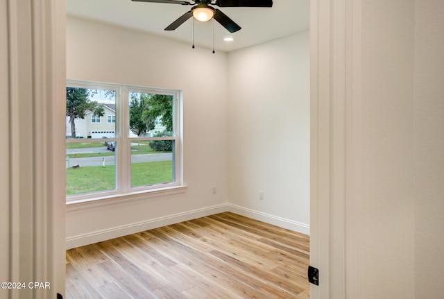 empty room with ceiling fan and light hardwood / wood-style floors