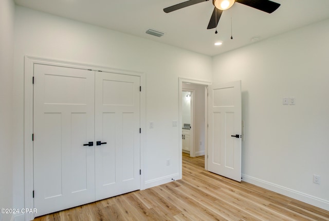 unfurnished bedroom featuring ceiling fan, a closet, and light hardwood / wood-style flooring