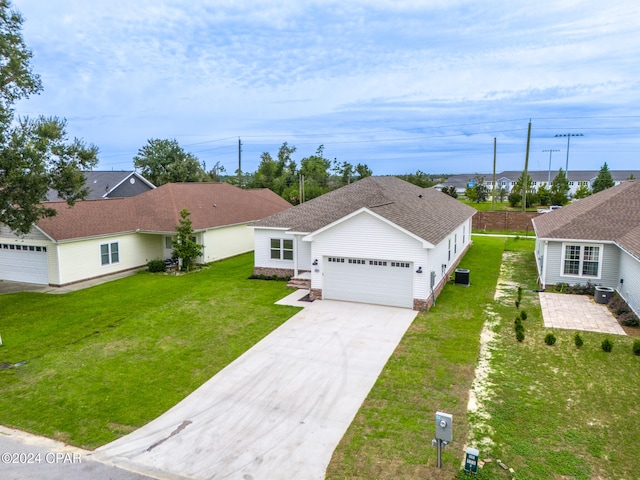 view of front of property with central AC unit and a front lawn