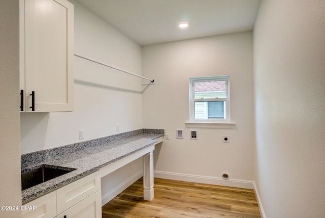 laundry room with hookup for an electric dryer, light hardwood / wood-style flooring, hookup for a washing machine, and sink