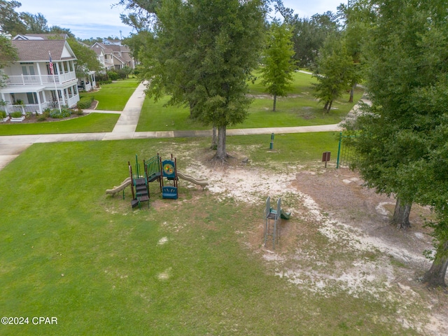 surrounding community featuring a playground and a yard