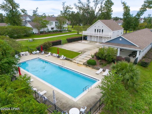 view of swimming pool featuring a yard and a patio area