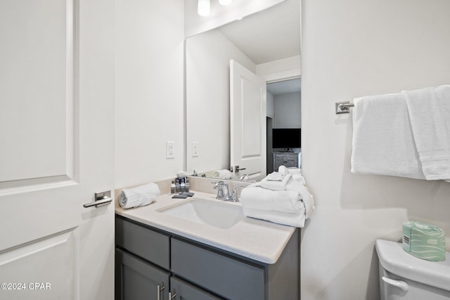 bathroom featuring vanity and toilet