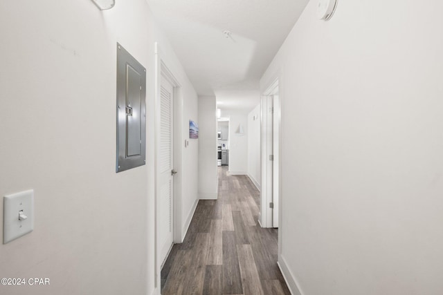 hall with dark hardwood / wood-style flooring and electric panel