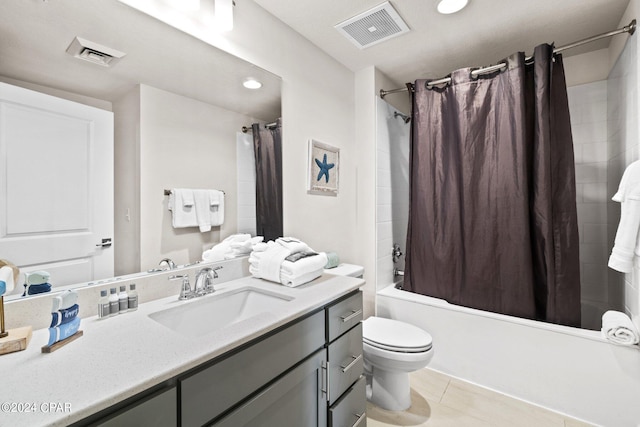 full bathroom featuring shower / bath combo with shower curtain, tile patterned floors, vanity, and toilet