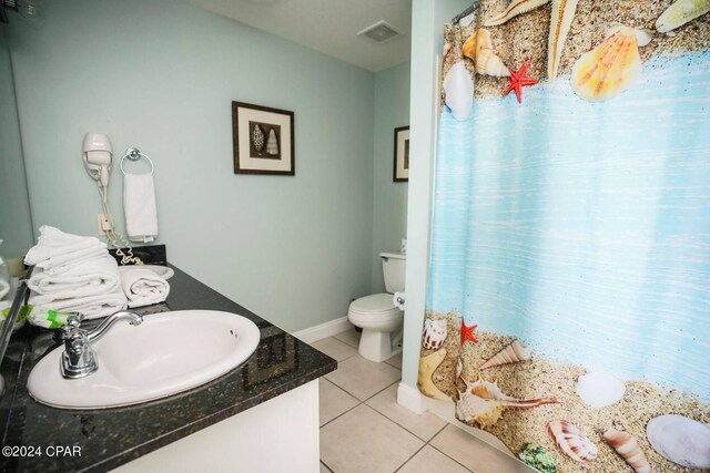 bathroom featuring vanity, tile patterned floors, and toilet