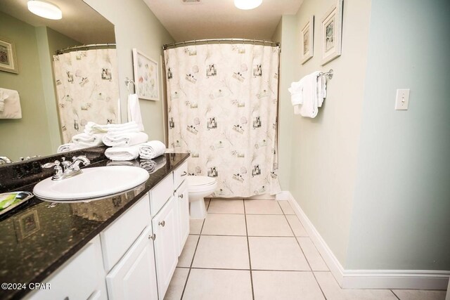 bathroom with vanity, tile patterned floors, and toilet