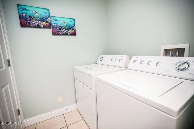 laundry area featuring separate washer and dryer and light tile patterned flooring