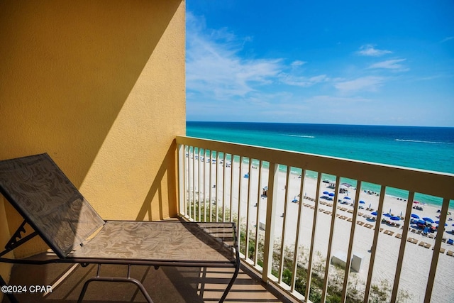 balcony featuring a view of the beach and a water view