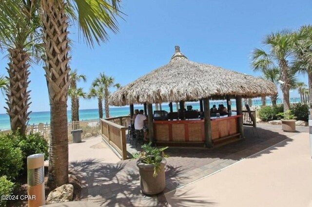 view of patio featuring a gazebo and a water view