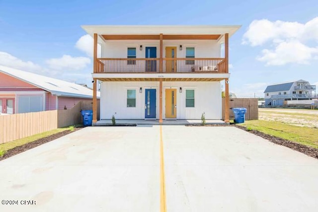 back of house featuring a balcony