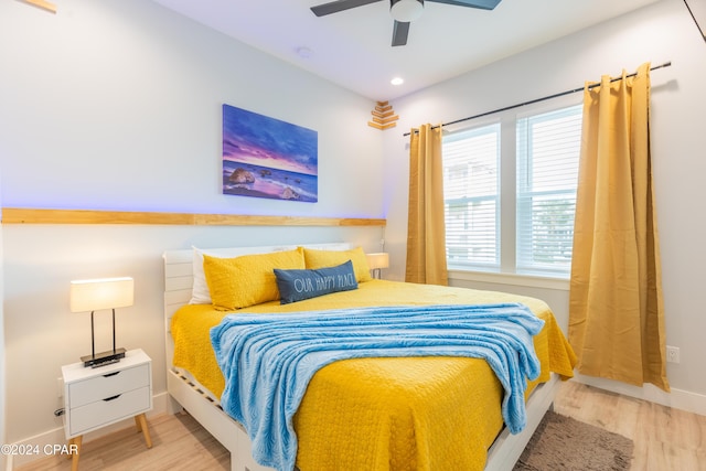 bedroom with ceiling fan and light hardwood / wood-style flooring