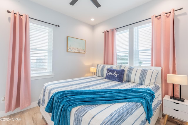 bedroom featuring multiple windows, light wood-type flooring, and ceiling fan