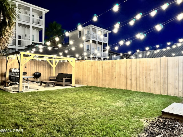 yard at night featuring a patio area