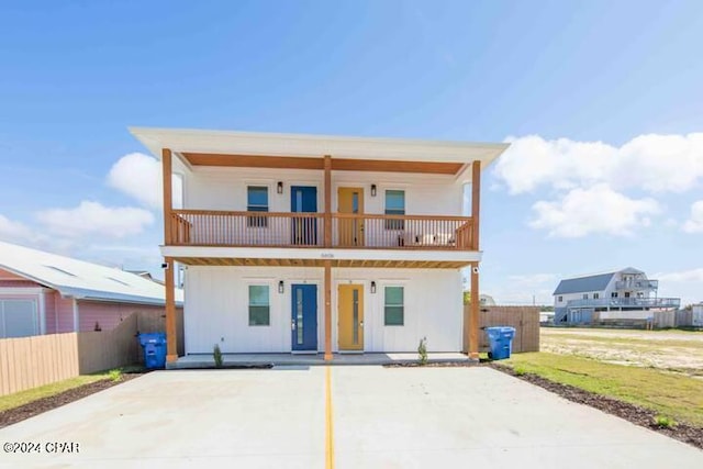 back of property featuring a balcony