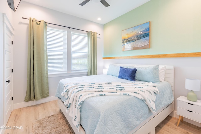 bedroom with ceiling fan and light wood-type flooring