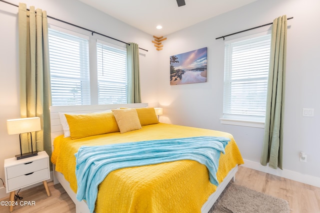 bedroom with ceiling fan and light hardwood / wood-style flooring