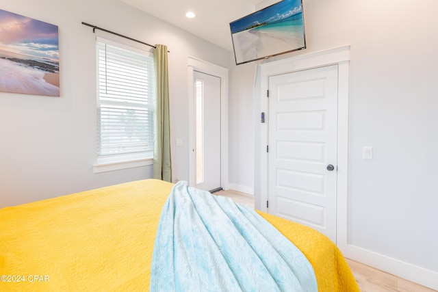 bedroom with wood-type flooring and a closet