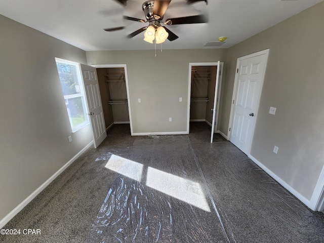 unfurnished bedroom with a ceiling fan, a walk in closet, carpet flooring, and baseboards