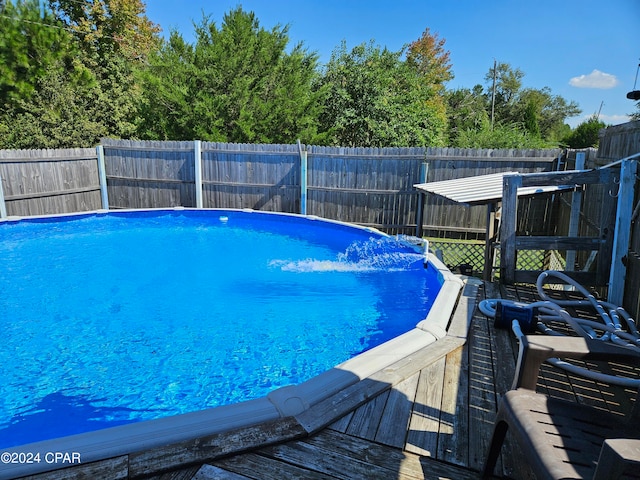 view of swimming pool with a deck