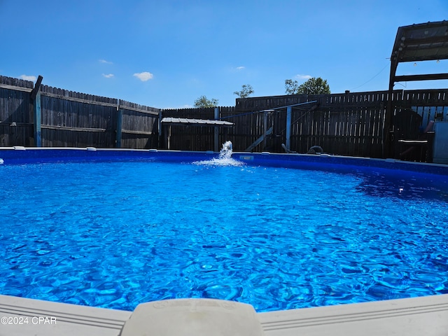 view of pool with pool water feature