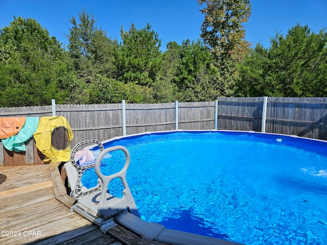 view of swimming pool with a deck