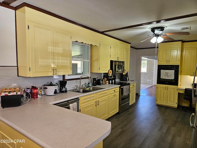 kitchen with ceiling fan, sink, dark wood-type flooring, stainless steel appliances, and ornamental molding