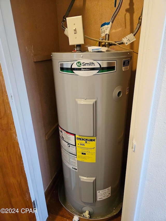 utility room featuring electric water heater