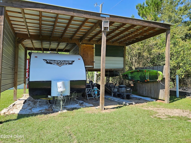 view of parking / parking lot with a yard and a carport