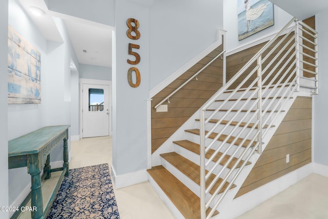 staircase featuring concrete floors