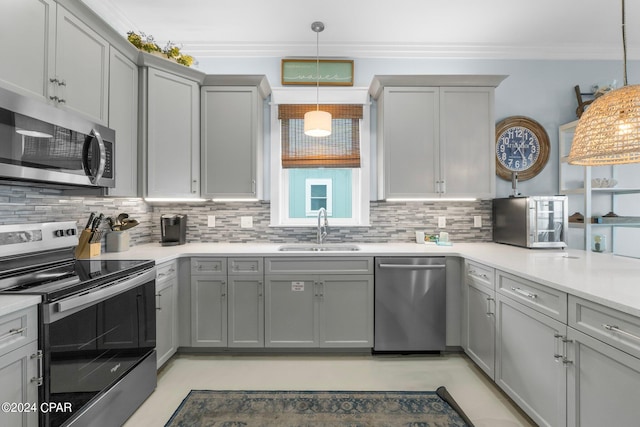 kitchen with gray cabinetry, appliances with stainless steel finishes, sink, and decorative light fixtures