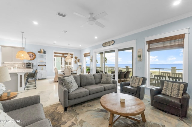 living room with crown molding, a water view, and ceiling fan