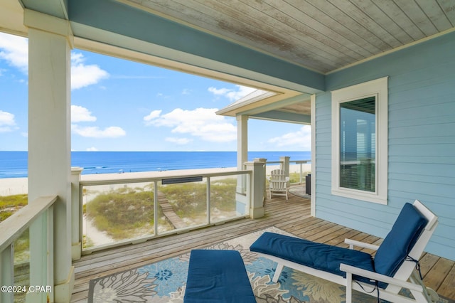 balcony with a deck with water view and a beach view