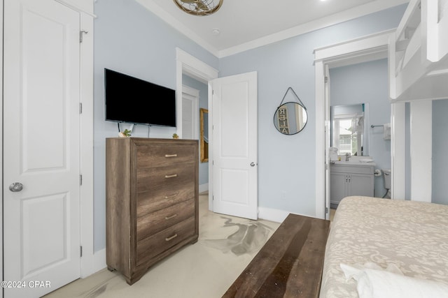 bedroom featuring crown molding and ensuite bath