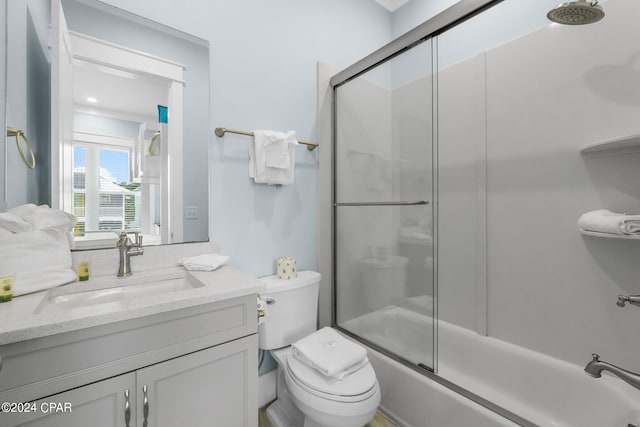 full bathroom with vanity, toilet, and shower / bath combination with glass door