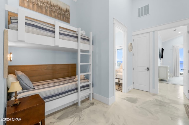 carpeted bedroom featuring a closet, lofted ceiling, and multiple windows