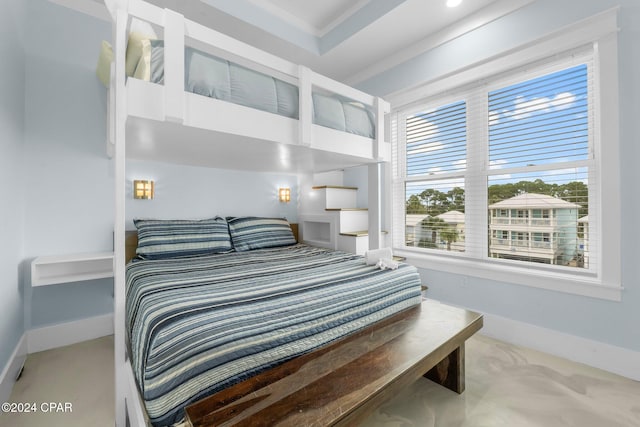 bedroom with crown molding and light carpet