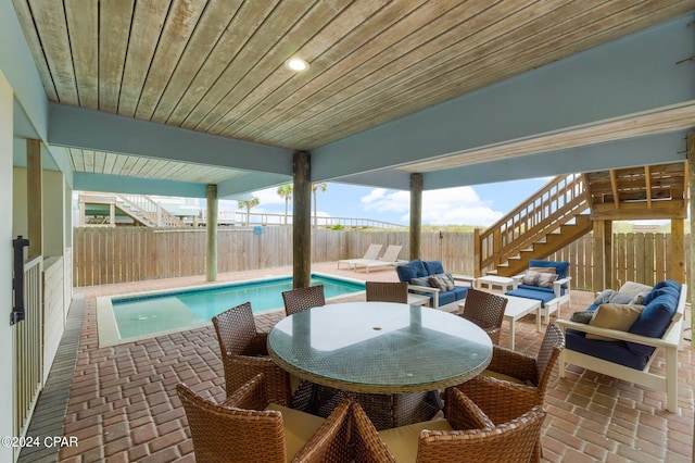 view of patio with a fenced in pool and an outdoor living space