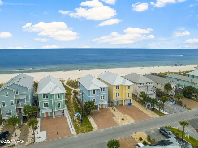 drone / aerial view featuring a water view and a beach view