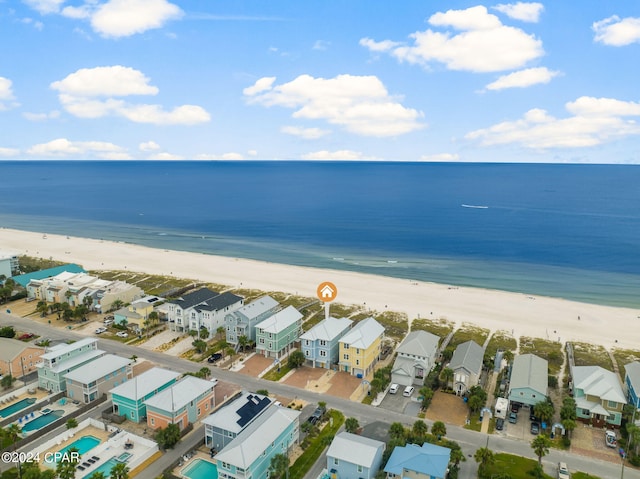 drone / aerial view featuring a water view and a beach view